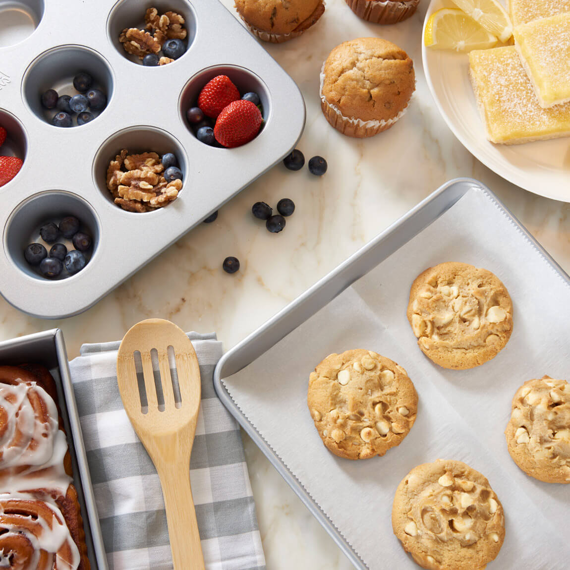 Decorative baking trays with cookies and fruits.